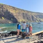 Where to go Snorkeling On The Big Island With Kids - Captain Cook Memorial The Brewer family, from the Family Can Travel blog, stand with their snorkel gear on at the Captain Cook Memorial, the best place to go snorkeling with kids on the Big Island.