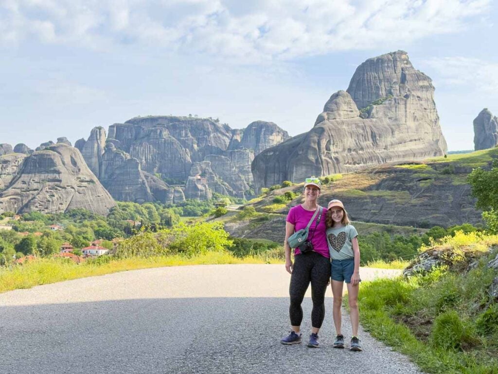 Celine Brewer, owner of FamilyCanTravel.com, enjoys a family hike with her daughter during a family trip to Meteora, Greece.