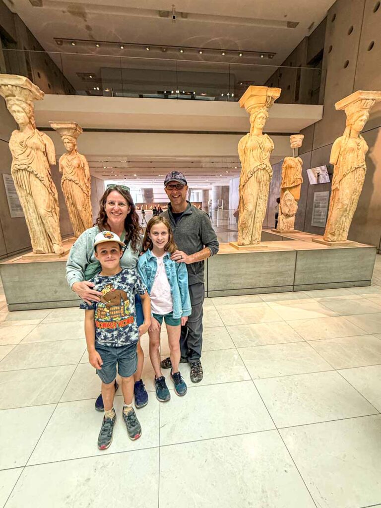 The Brewer family, from the Family Can Travel blog, stands in front of the real Caryatids at the Acropolis Museum.