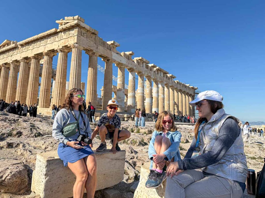Celine Brewer, owner of FamilyCanTravel.com, and her kids listen to their tour guide on a private tour of the Acropolis & Parthenon.