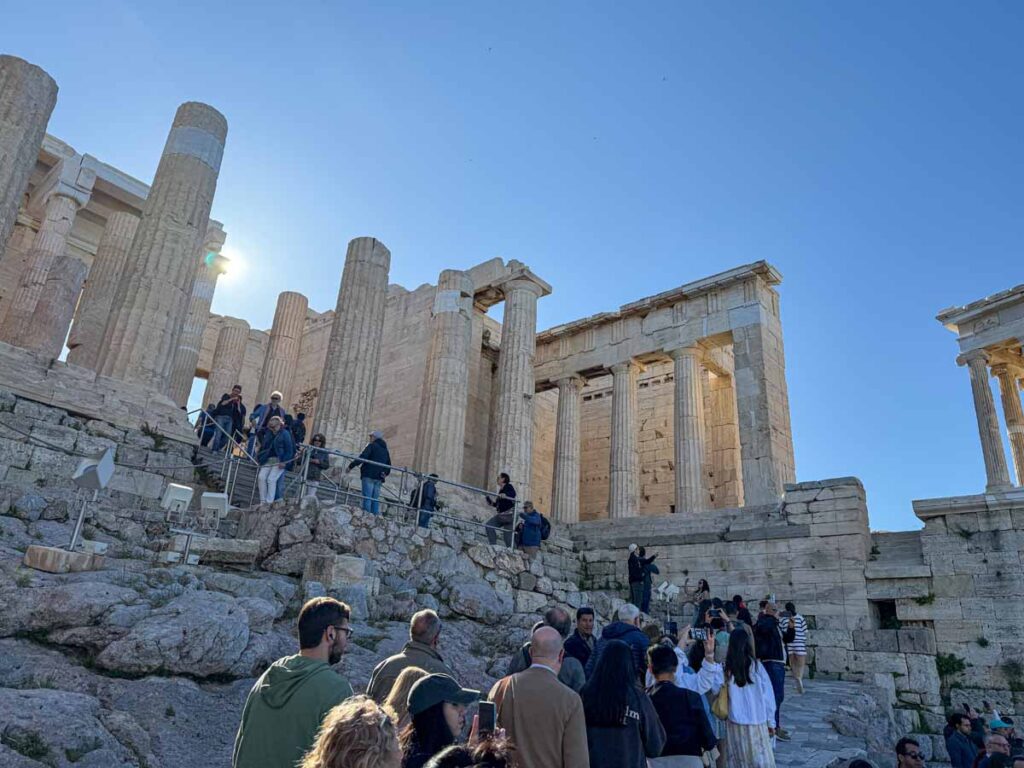The morning sun rises through Propylaea at the Acropolis in Athens, Greece.