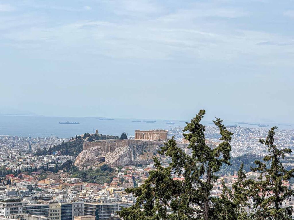 Amazing views of the Parthenon and the Aegean Sea from Lycabettus Hillย in Athens, Greece.