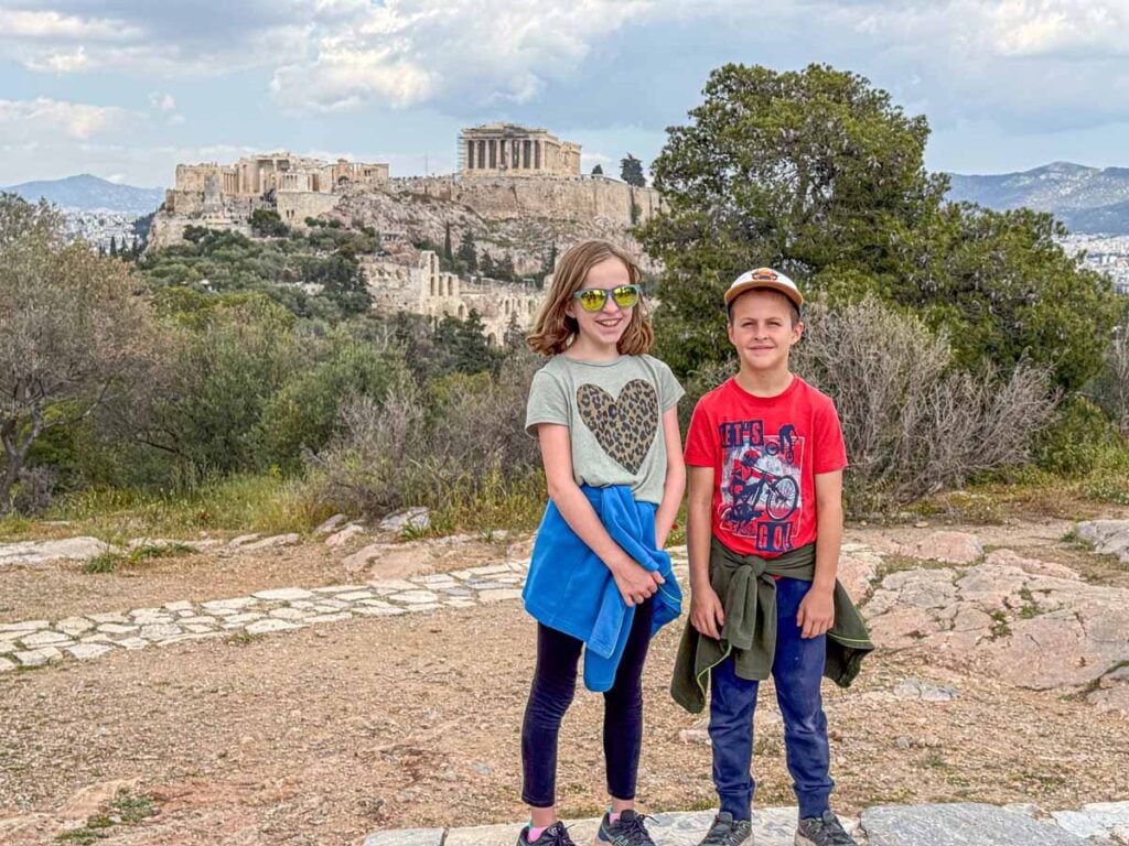 The Brewer kids, from the FamilyCanTravel.com blog, are excited to see the Parthenon from Philopappos Hill on the first day of their family trip to Athens.