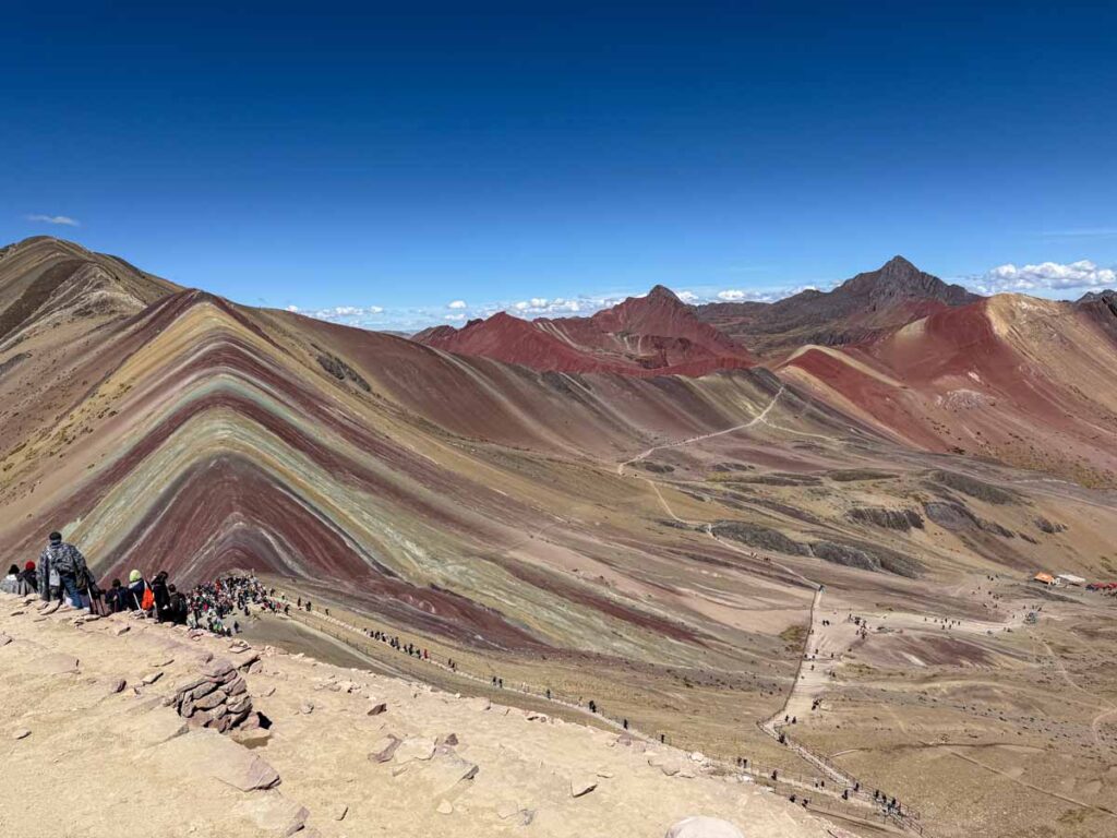 The colorful red mountains around Rainbow Mountain in Peru are equally beautiful.