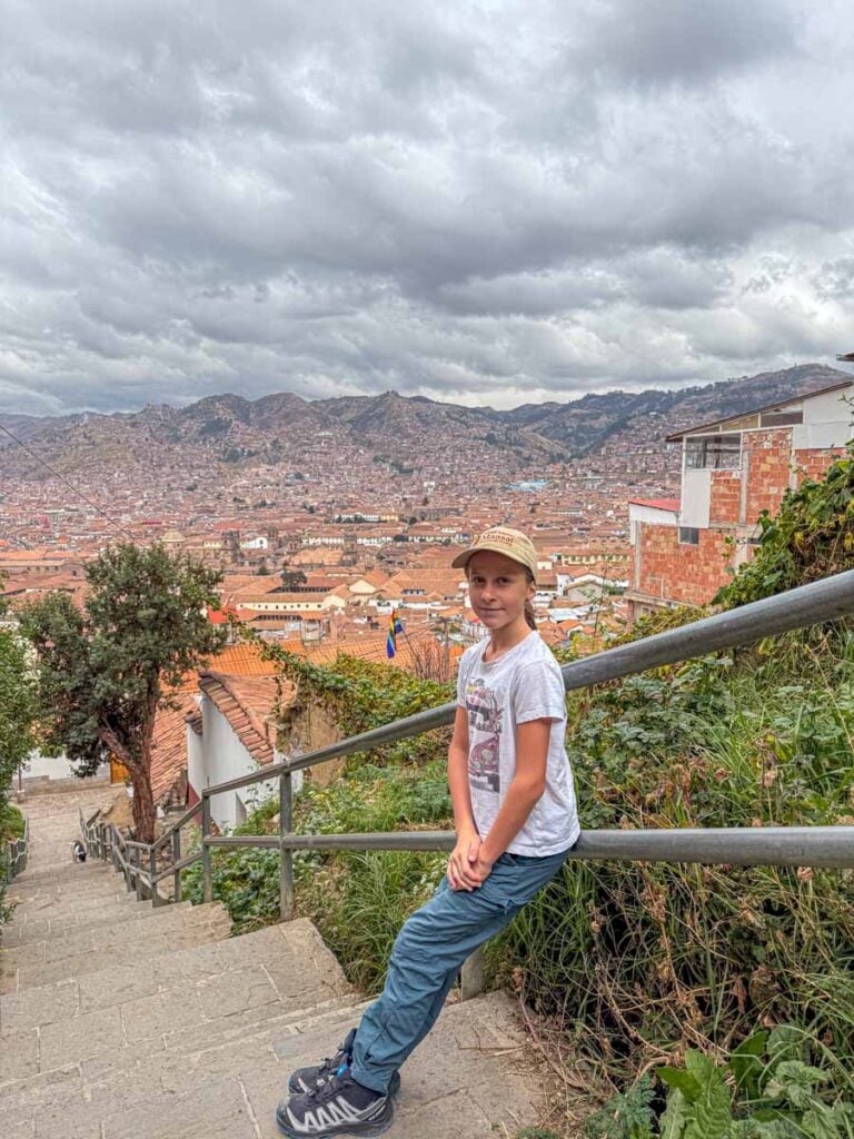 an 11-year old girl pauses to catch her breath while acclimatizing to the altitude on a family hike to Cristo Blanco in Cusco, Peru.
