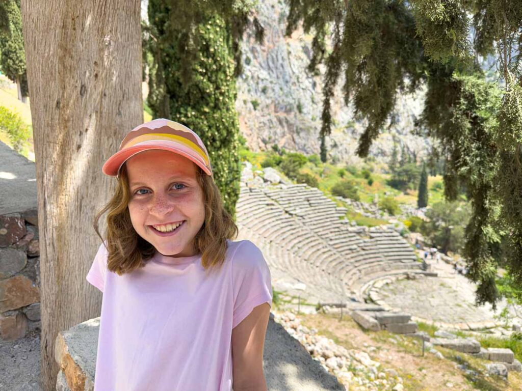 an 11-year old girl is all smiles during a visit to Delphi on a family trip to Greece.