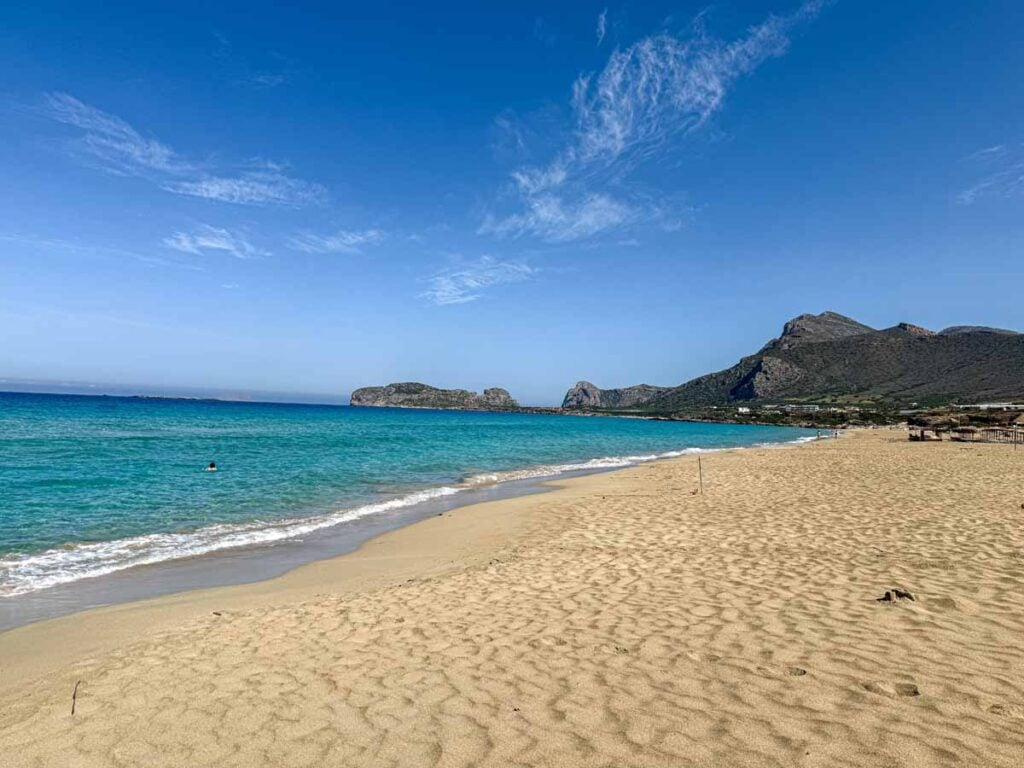 A long stretch of sandy beach at Falassarna Beach - one of the best family beaches on Crete, Greece.