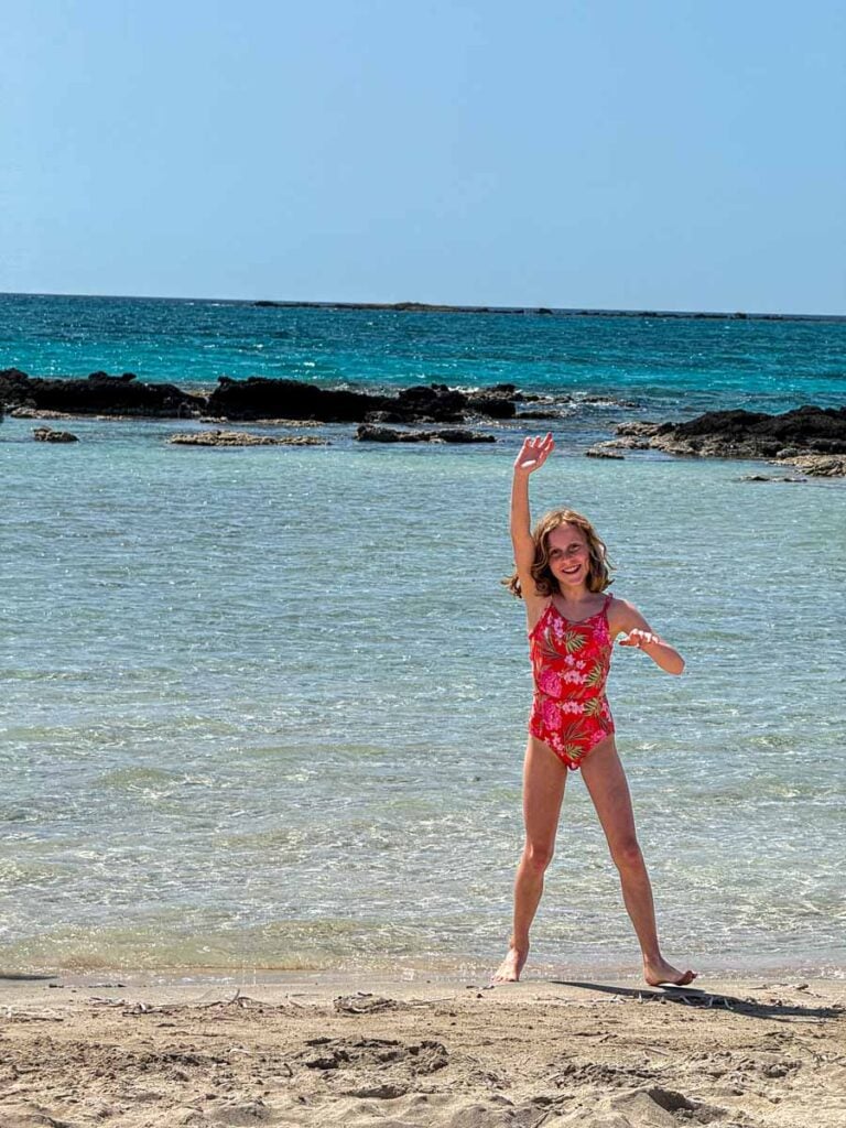 an 1--year old girl enjoys visiting Elafonisi Beach during a family trip to Crete, Greece.