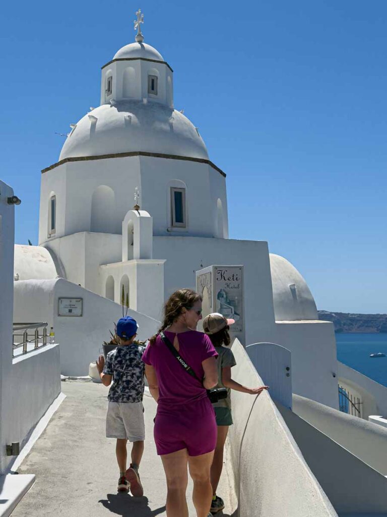 Celine Brewer, owner of FamilyCanTravel.com, walks with her kids during a family trip to Santorini, Greece.