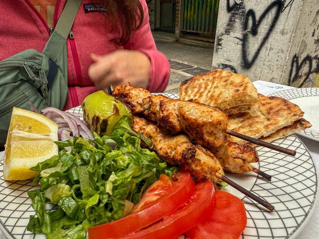 a meal of chicken souvlaki with salad.