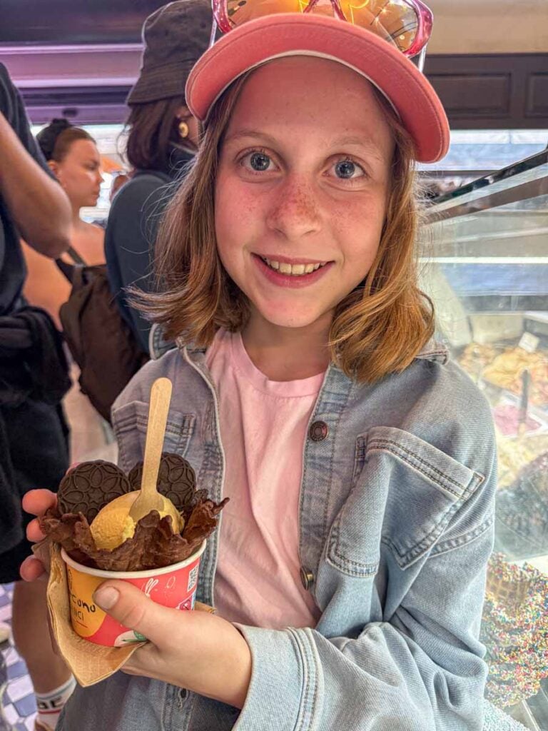 an 11-year old girl enjoys a gelato treat while on a family trip to Greece.