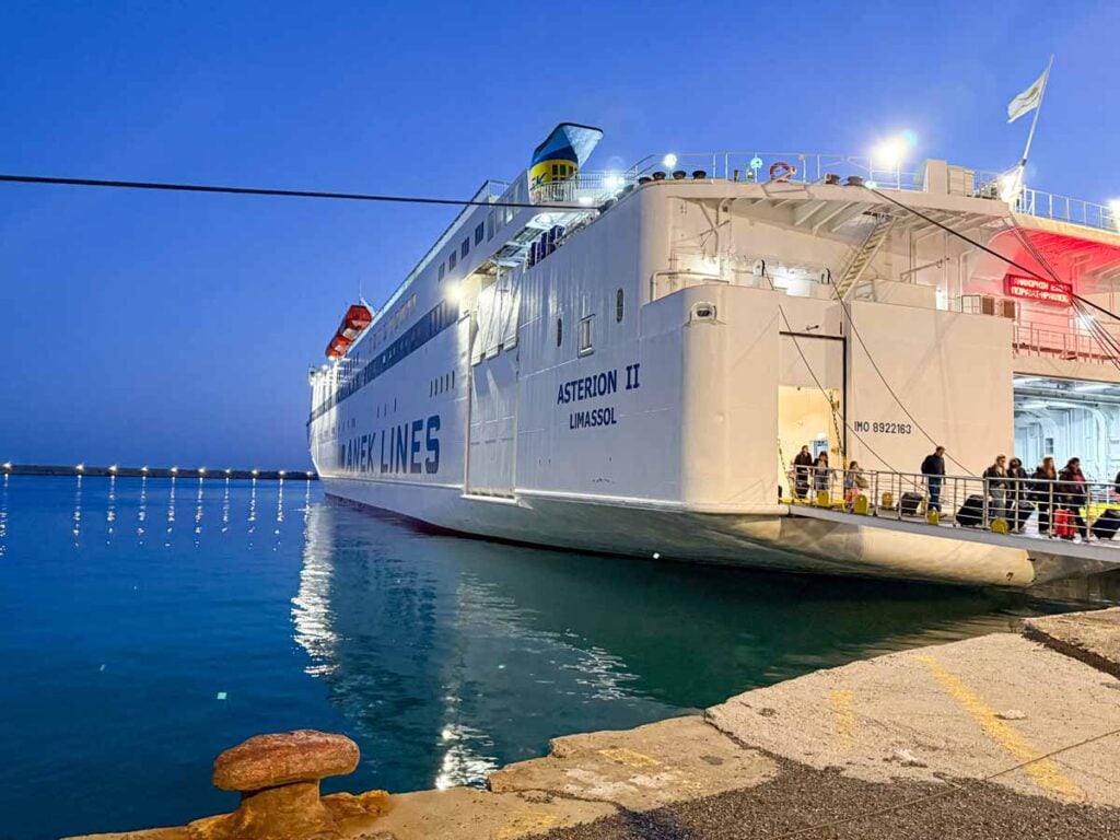 An overnight ferry ferry from Athens to Crete is lit up at night.