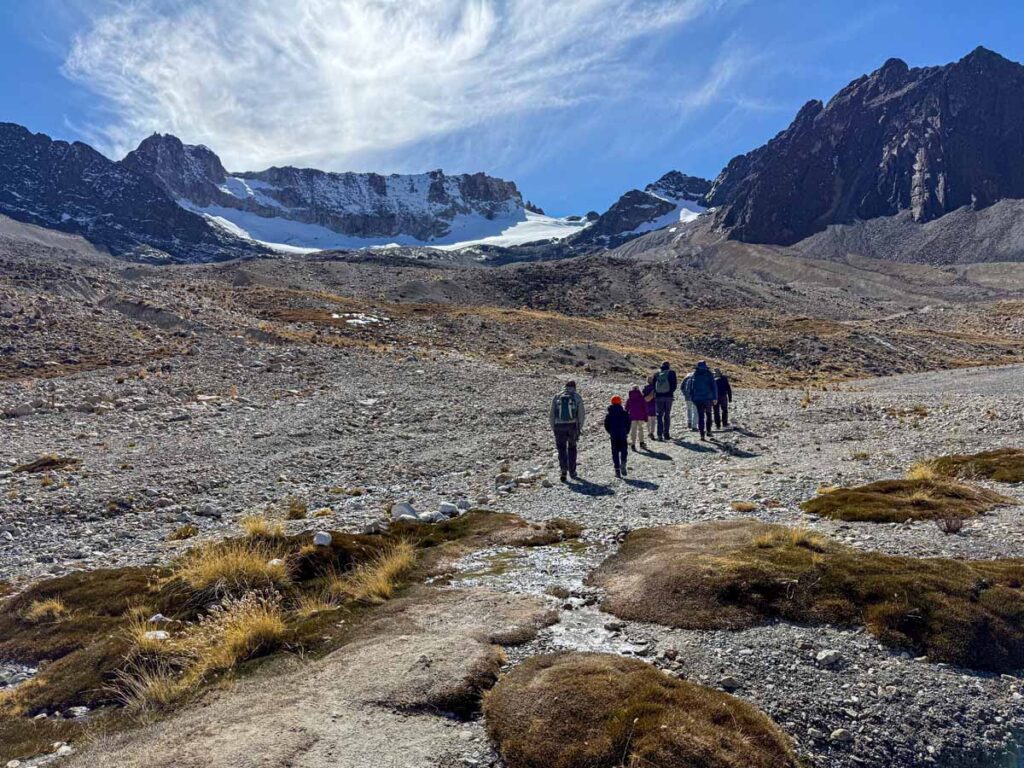 The Brewer family, from the FamilyCanTravel.com blog, hike to the Emerald Lagoon on Mt. Charquini while on a family trip to La Paz, Bolivia.
