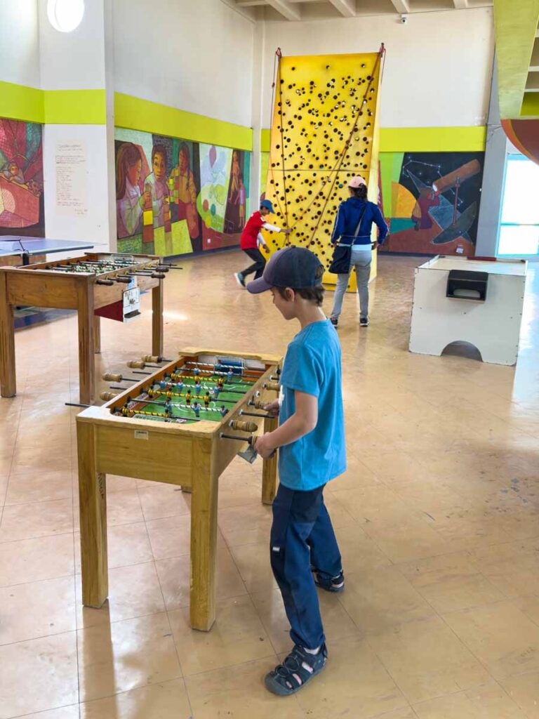 a 9-year old boy plays foosball at the Pipiripi Children’s Museum while on a family trip to La Paz, Bolivia.