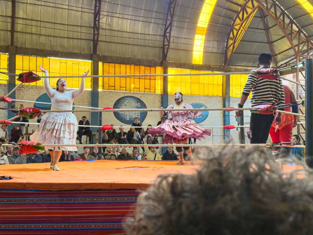 a female wrestler gets the crowd excited during the Cholitas Wrestling matches in La Paz, Bolivia.