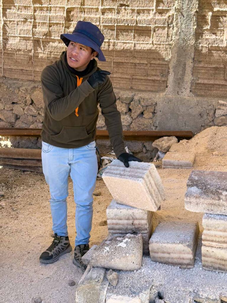 a tour guide explains the salt extraction process at the Colchani Salt Refinery in Uyuni, Bolivia.