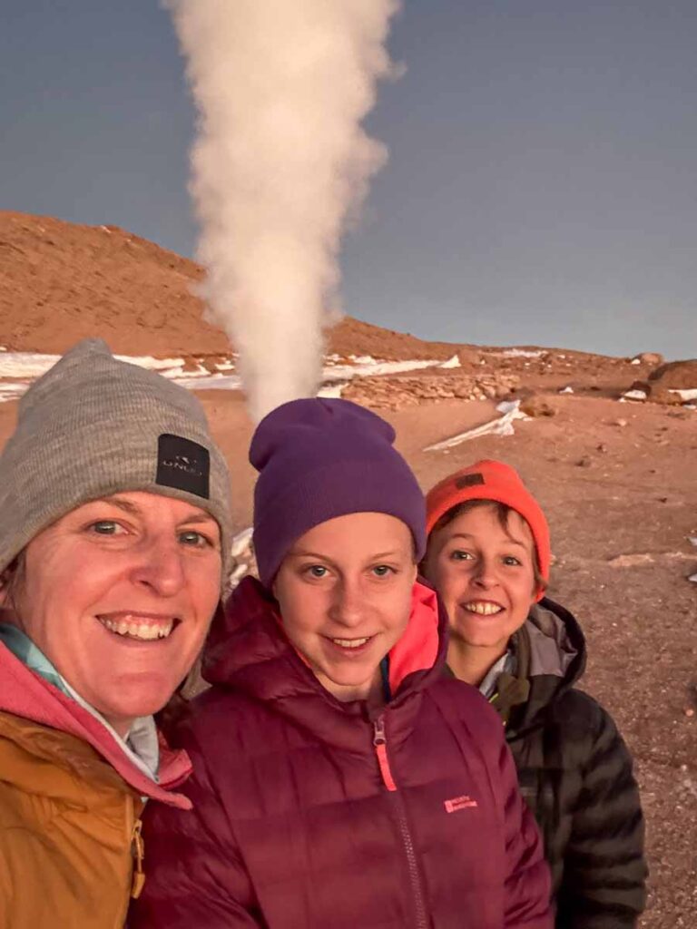 Celine Brewer, owner of FamilyCanTravel.com, enjoys a sunrise visit to some geysers while on a family-friendly tour of the Uyuni Salt Flats in Bolivia.