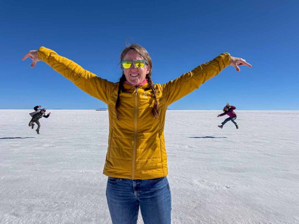 Celine Brewer, owner of FamilyCanTravel.com, appears to be dropping her tiny kids in a forced perspective picture while on a family vacation to the Uyuni Salt Flats.