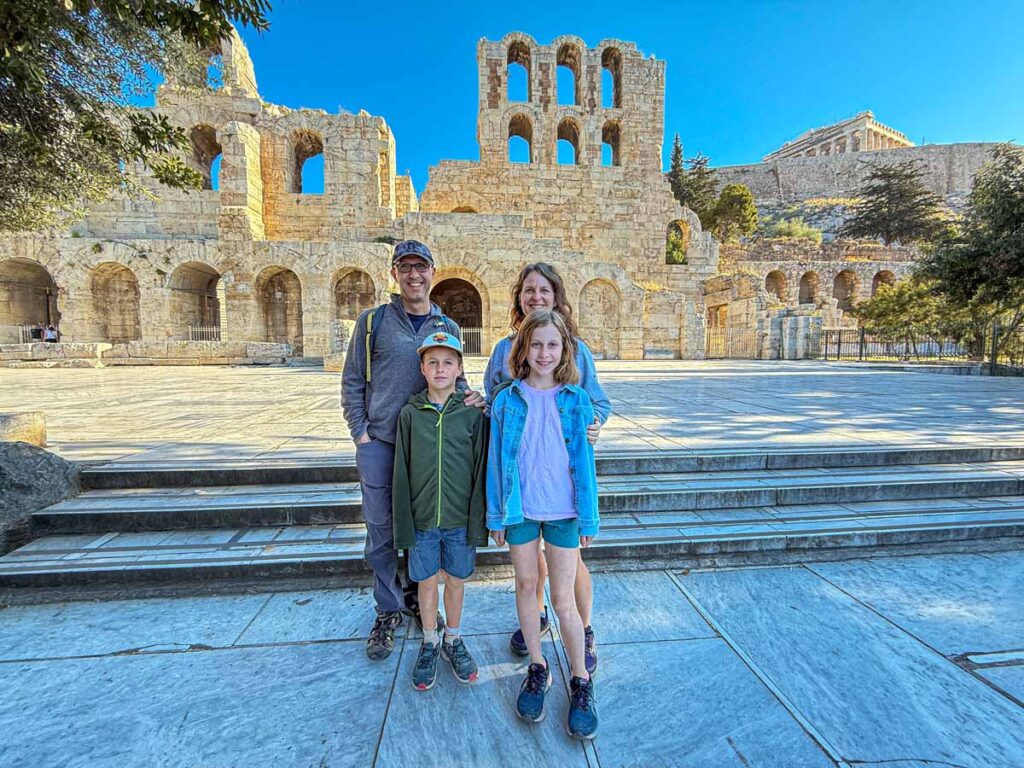 The Brewer family in front of the Sanctuary of the Nymph while on a private tour of the Acropolis.