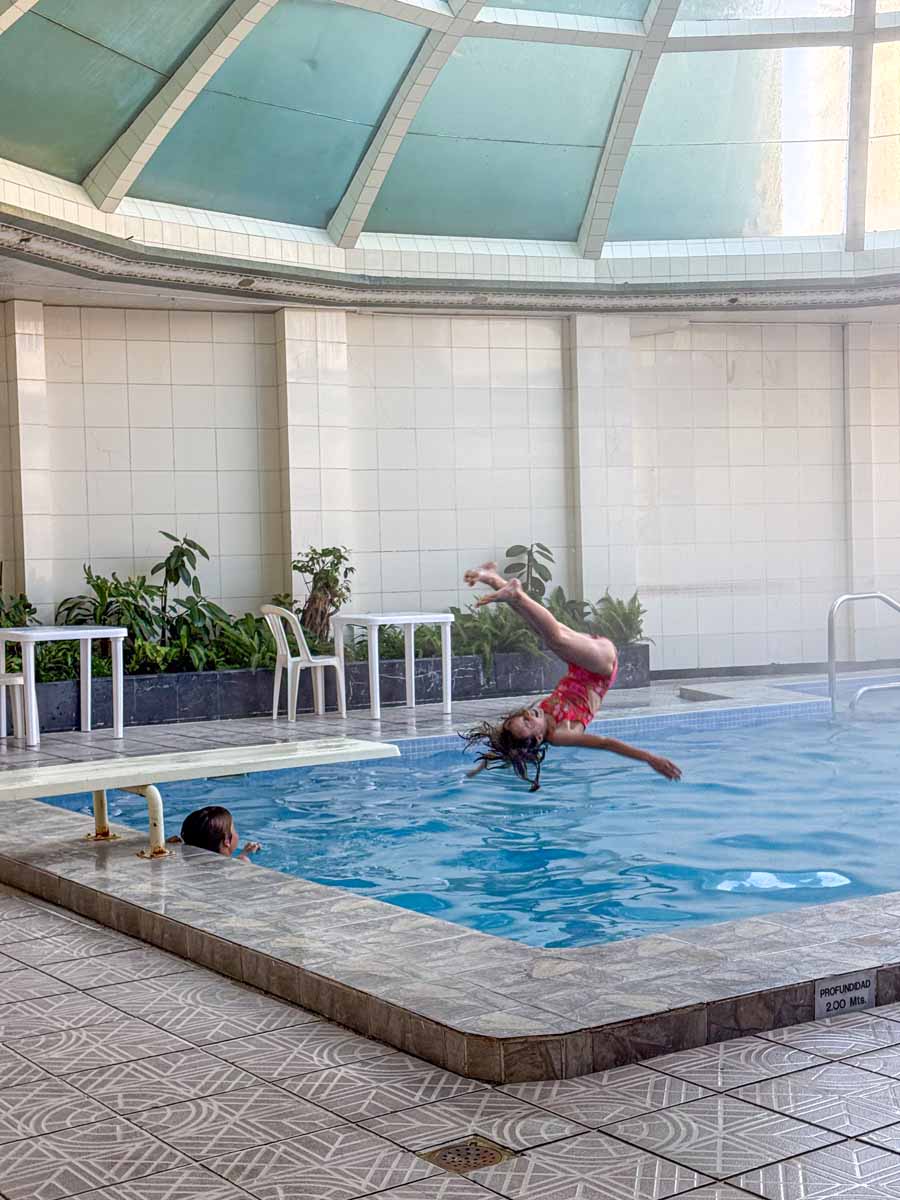 Where To Stay with kids in La Paz Bolivia - Hotel Presidente - swimming pool an 11-year old girl does a backflip into the indoor swimming pool at Hotel Presidente in downtown La Paz, Bolivia.