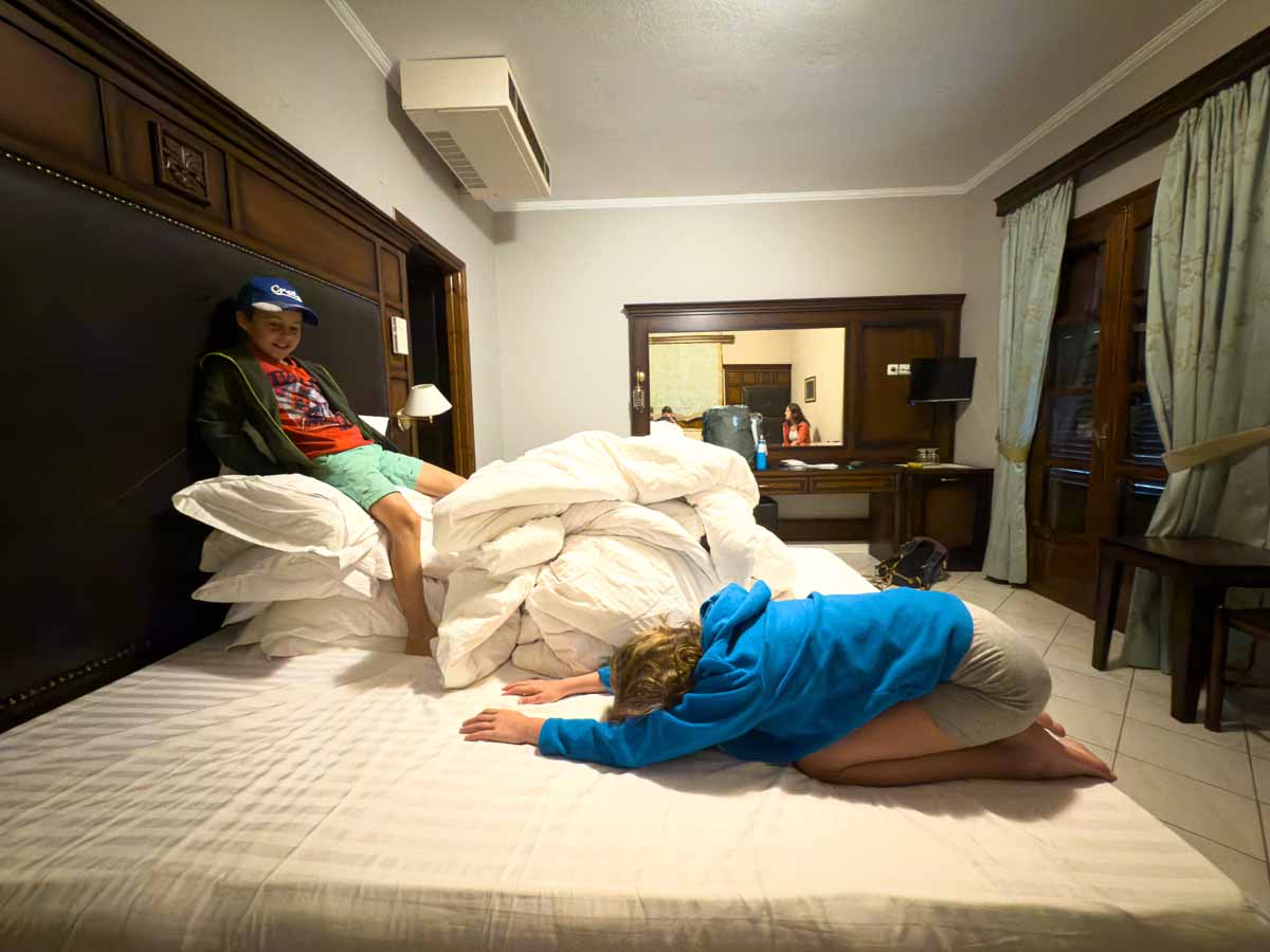 Where to stay in Meteora with kids - Hotel Kastraki Two kids goof around in the Hotel Kastraki - a family-friendly hotel in Meteora, Greece.