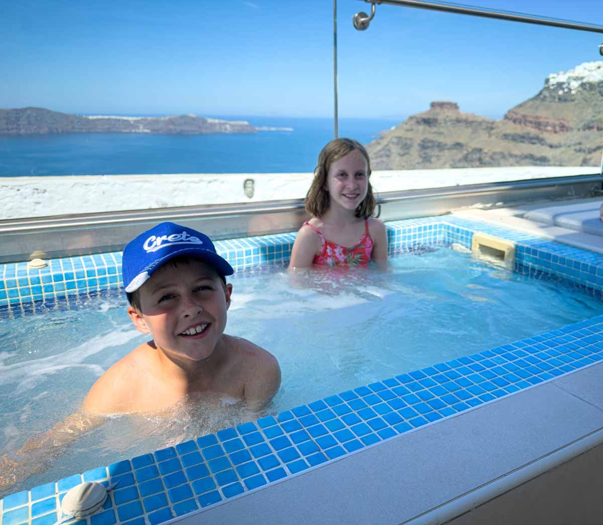 family-friendly Santorini Hotels - Ellinon Thea Hotel - hot tub with caldera view The Brewer kids soak in their private hot tub at the Ellinon Thea Hotel - a family friendly hotel in Santorini, Greece.