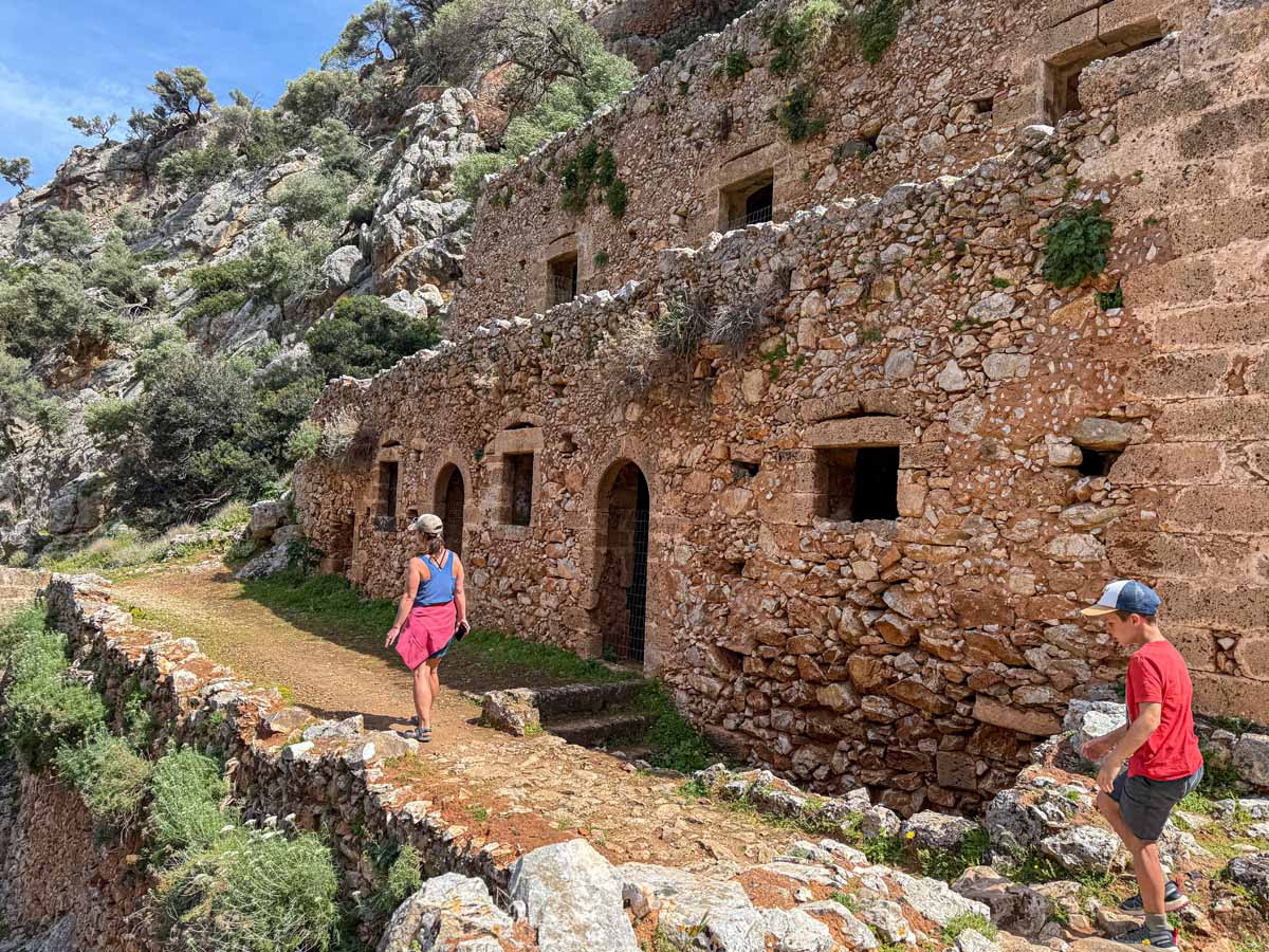 Celine Brewer, owner of FamilyCanTravel.com, hikes with her son to the Katholiko Fjord during a family trip to Crete, Greece.
