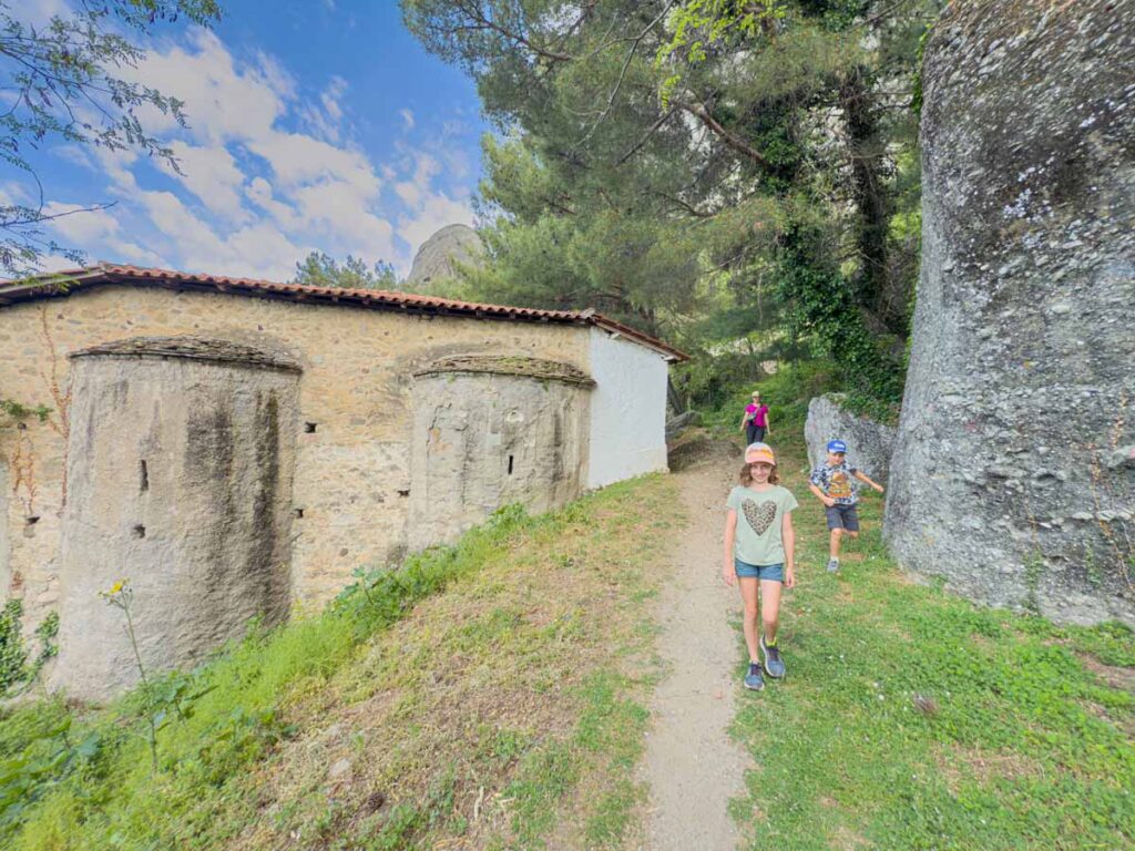 The kids from FamilyCanTravel.com hike through the town of Kalabaka on a family hiking trip to Meteora.