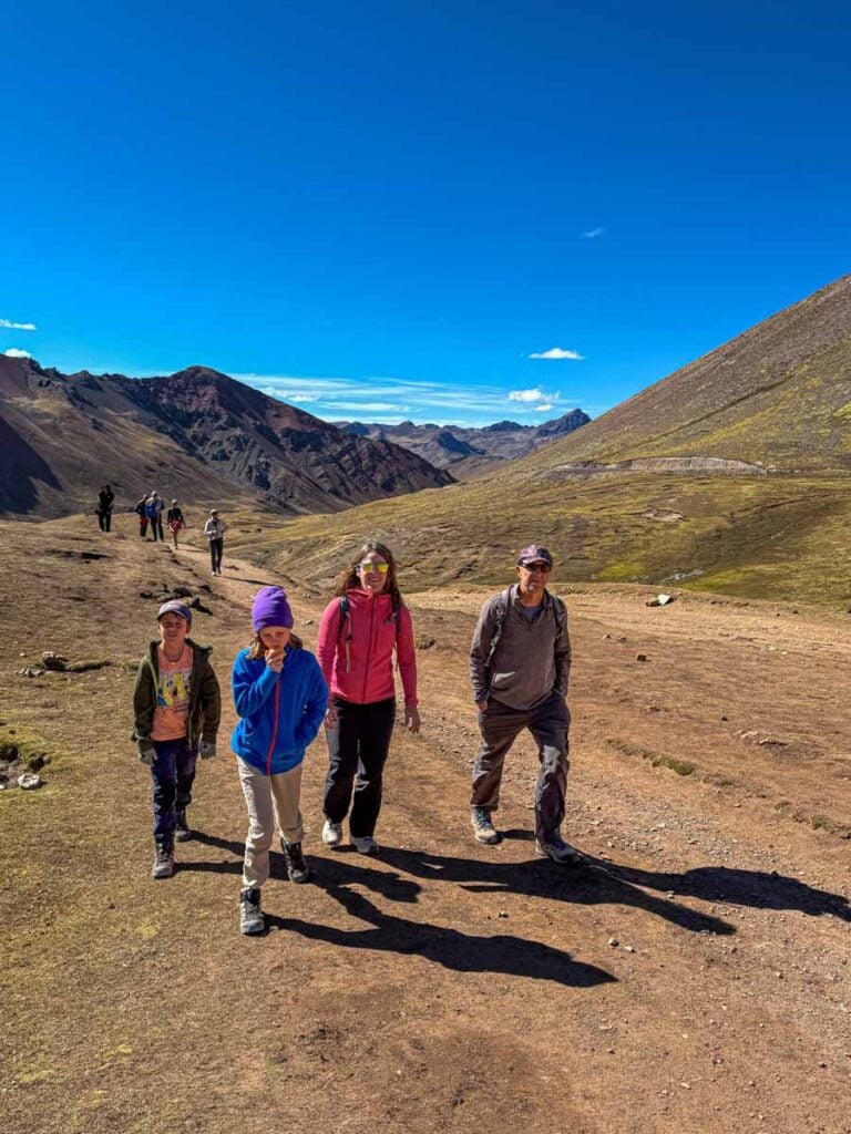 Dan and Celine Brewer, owners of FamilyCanTravel.com, take their kids to Rainbow Mountain while on a family vacation to Cusco, Peru.