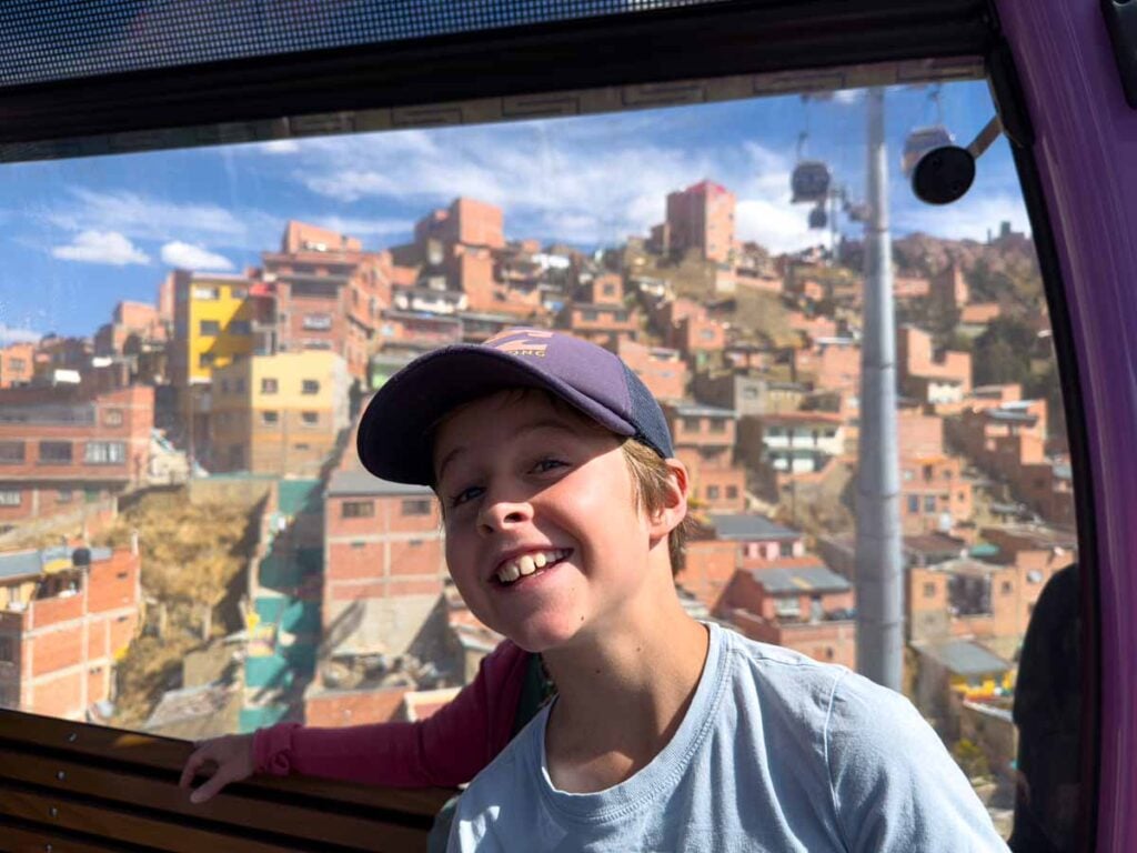 a 9-year old boy enjoys riding the cable cars on a family trip to La Paz, Bolivia.