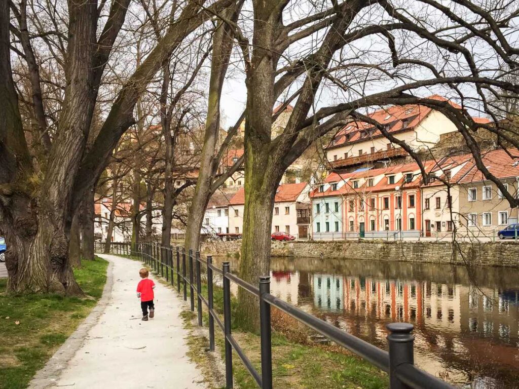 a young boy on a family vacation to Cesky Krumlov goes on a walk with his family.