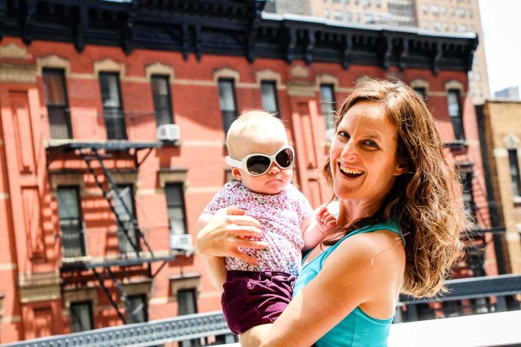Celine Brewer, owner of FamiluyCanTravel.com, walks the High Line with her baby during a family trip to New York City.