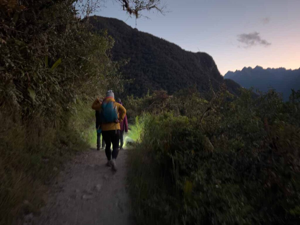 Celine Brewer, owner of FamilyCanTravel.com, hikes in the dark with her kids on the final day of hiking the Inca Trail to Machu Picchu.