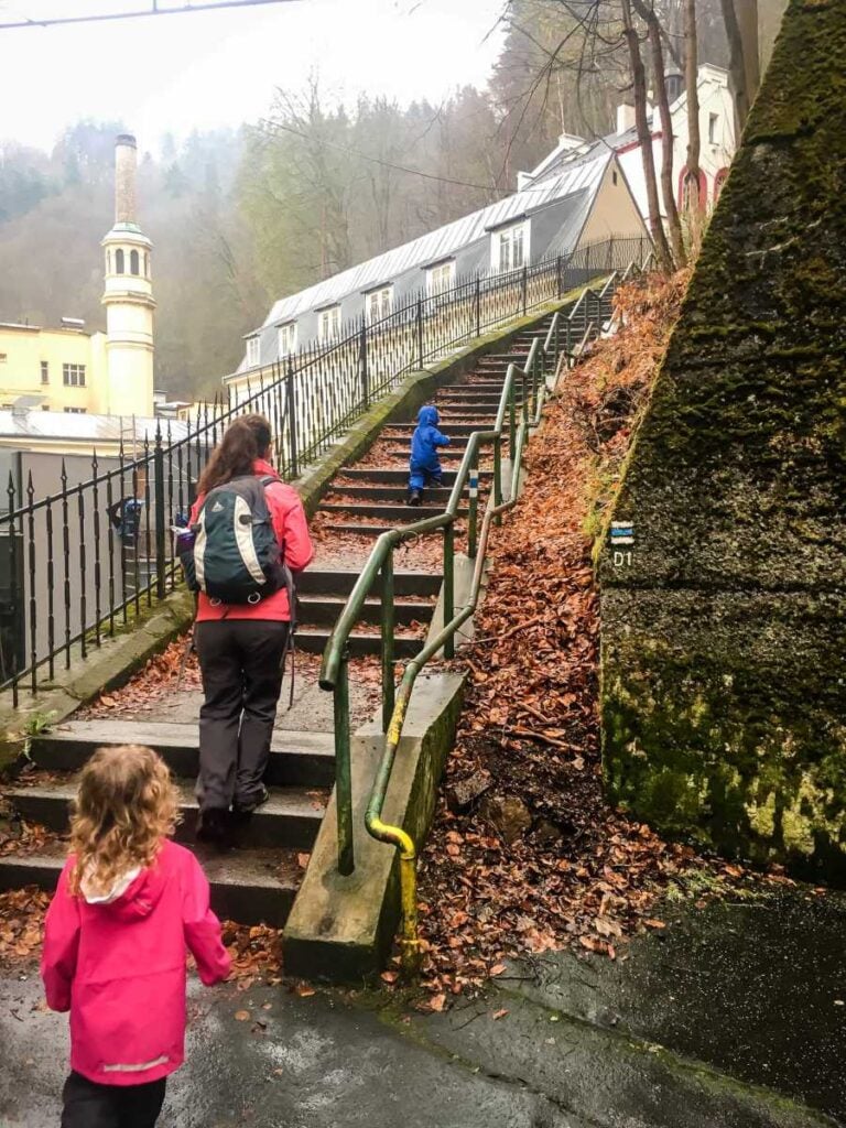 Celine Brewer, owner of FamilyCanTravel.com, hikes with her kid to the Diana Lookout while on a family trip to Karlovy Vary, Czech Republic.