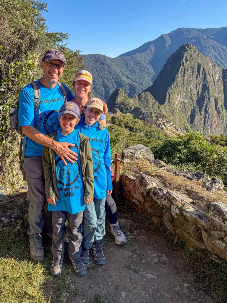 The Brewer family, from the Family Can Travel blog, enjoy the first views of Machu Picchu after reaching the Sun Gate on the final day of their family-friendly Inca Trail tour.