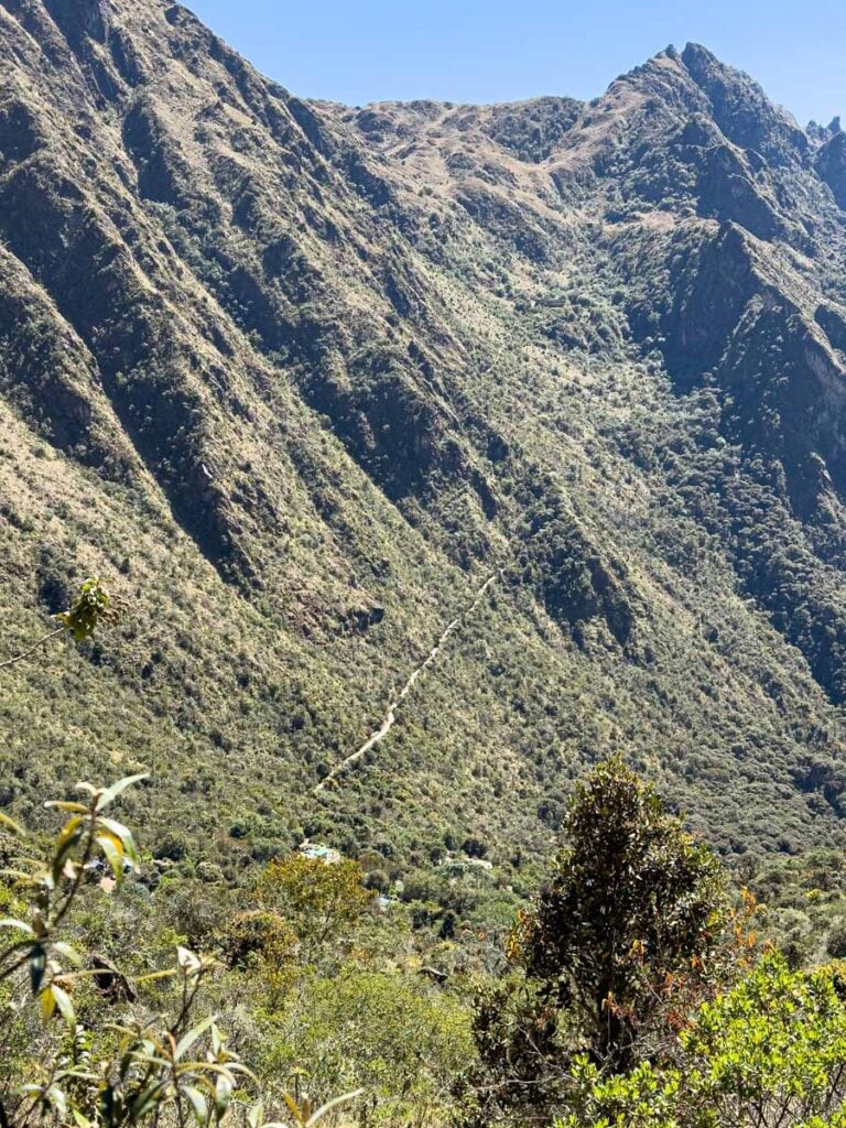 the hiking trail up Runkuraqay Pass is visible on the side of the mountain.