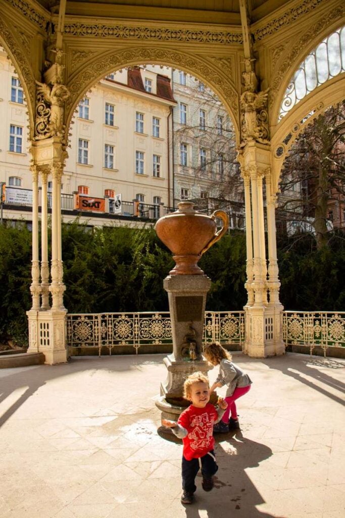 The Brewer kids, from the Family Can Travel blog, play near a colonnade in Karlovy Vary, Czech Republic.