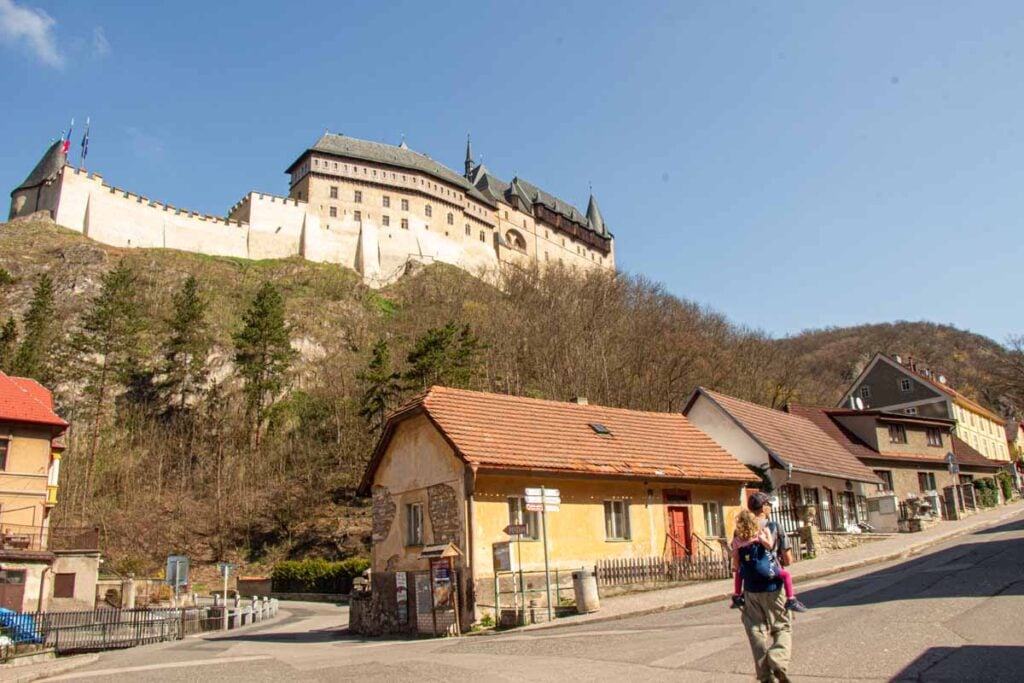 Dan Brewer, owner of FamilyCanTravel.com, carries his young daughter to visit Day Trips from Prague - Karlstejn Castle while on a family trip to the Czech Republic.