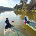 Manu National Park with kids - Paddling Salvador Lake The Brewer kids, from the FamilyCanTravel.om blog, try paddling the catamaran on Salvador Lake in Manu National Park, Peru.