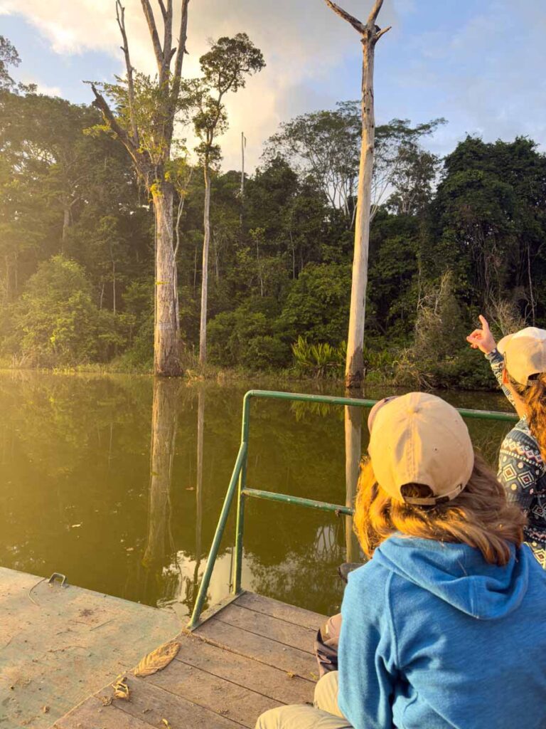 Celine Brewer looks for birds on a wildlife viewing boat tour on Salvador Lake, Peru.