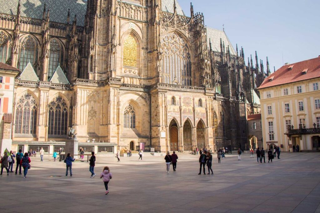 A 4-year old girl from the Family Can Travel blog, walks outside the Prague Castle while visiting with her family.