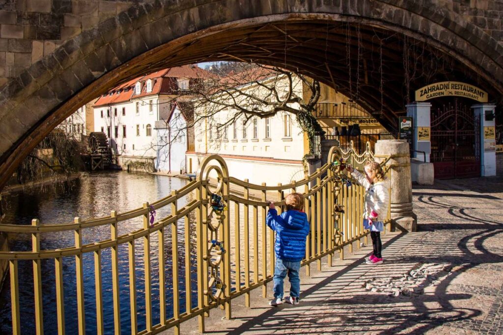 the kids from the FamilyCanTravel.com blog enjoy a riverside walk in Kampa Park during a family vacation in Prague.