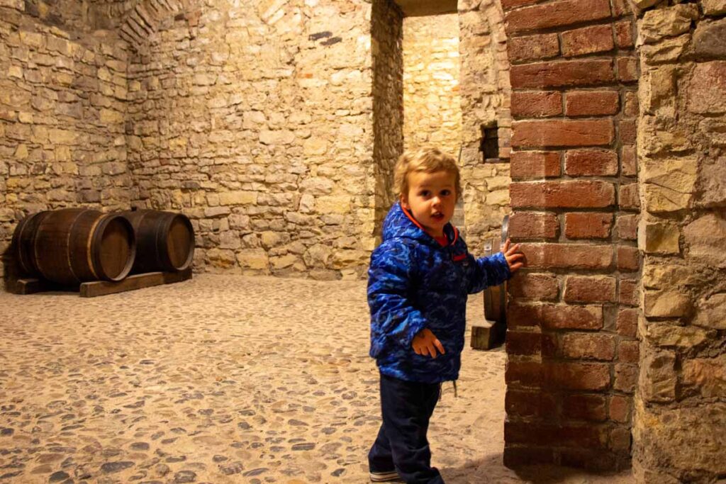 a 2-year old boy explores the basement of Old Town Hall while on a family-friendly tour in Prague.