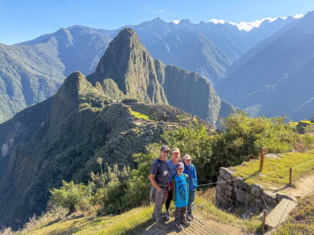 Dan and Celine Brewer, owners of FamilyCanTravel.com, visit Machu Picchu with their kids after successfully hiking the Inca Trail over 4 days.