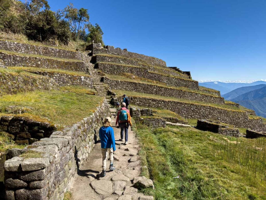The Brewer family walks through the Phuyupatamarca ruins on Day 3 of their family hiking trip on the Inca Trail.
