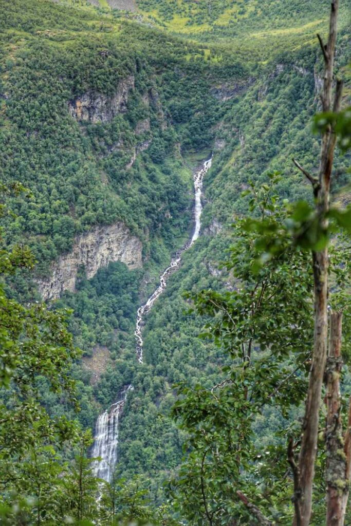a towering waterfall seen across the Geirangerfjord on the Skageflå hiking trail.