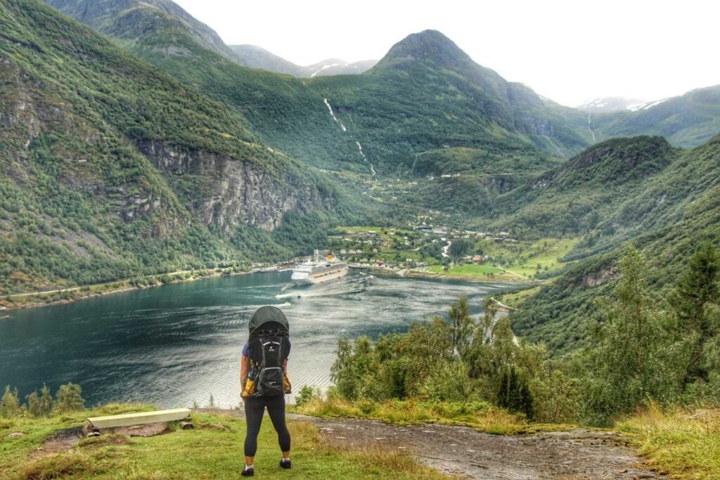 Celine Brewer, owner of FamilyCanTravel.com, looks at Geiranger from an elevated viewpoint on the Skagefla Hiking Trail.