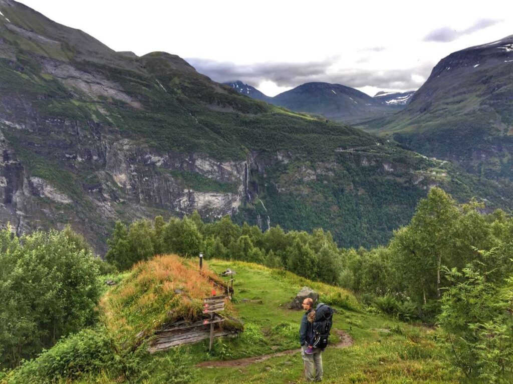 Dan Brewer, owner of FamilyCanTravel.com, enjoys views of Geiranger while visiting the Homlongsaetra farm on the Skagefla Hiking Trail.