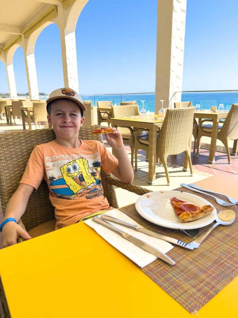 A 10-year old boy enjoys pizza from the lunch buffet at the San Jose Italian restaurant at the Cabo San Lucas Riu Palace.