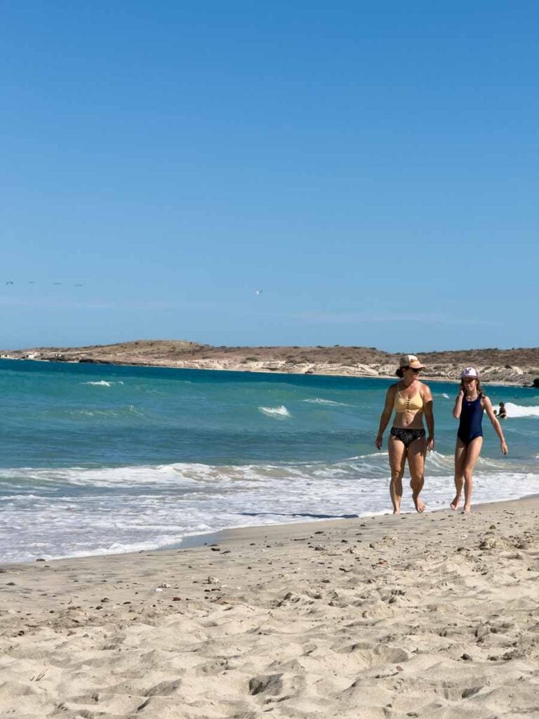 Celine Brewer and her daughter enjoy a family walk on Playa el Tecolote near La Paz, Mexico.